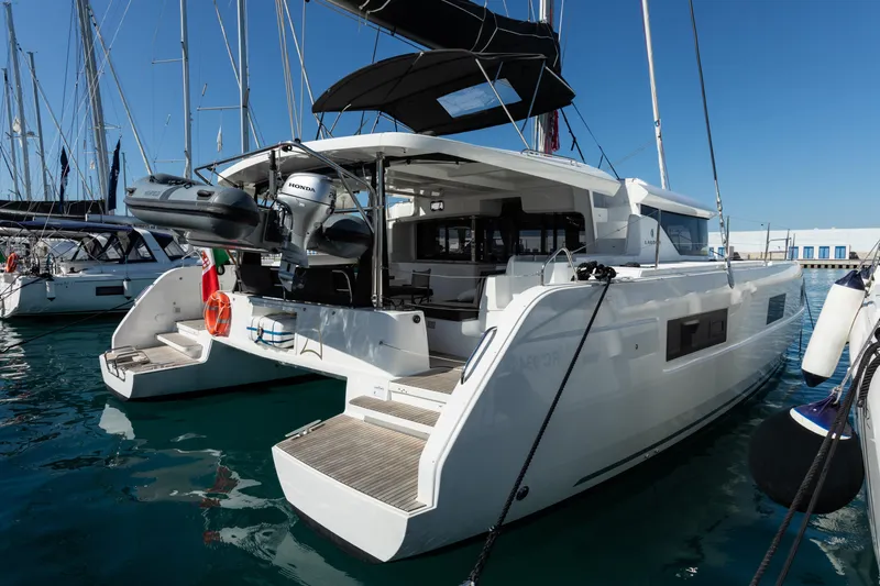 Twenty Cent Yacht Photos Pics 2021 Lagoon 46 catamaran docked at marina, featuring modern design and spacious deck.
