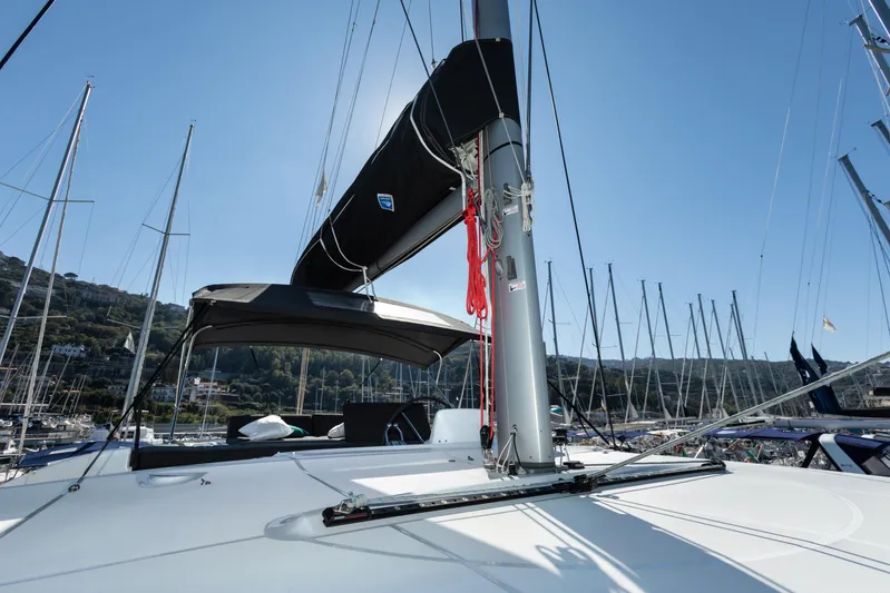 Twenty Cent Yacht Photos Pics 2021 Lagoon 46 catamaran docked in a marina, clear blue sky background.