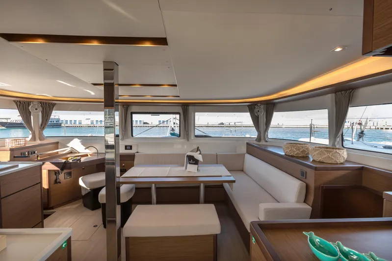 Twenty Cent Yacht Photos Pics Luxurious interior of 2021 Lagoon 46 catamaran with modern furnishings and panoramic windows.