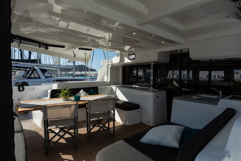 Twenty Cent Yacht Photos Pics Interior of 2021 Lagoon 46 catamaran with modern seating and dining area.
