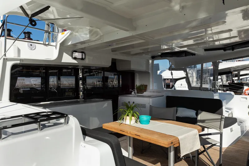 Twenty Cent Yacht Photos Pics Spacious deck of 2021 Lagoon 46 catamaran with seating and dining area.