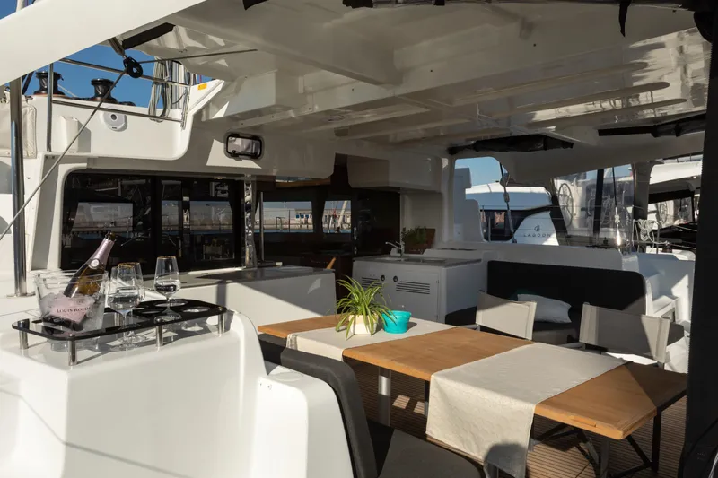 Twenty Cent Yacht Photos Pics Luxurious interior of 2021 Lagoon 46 yacht with dining area and champagne setup.