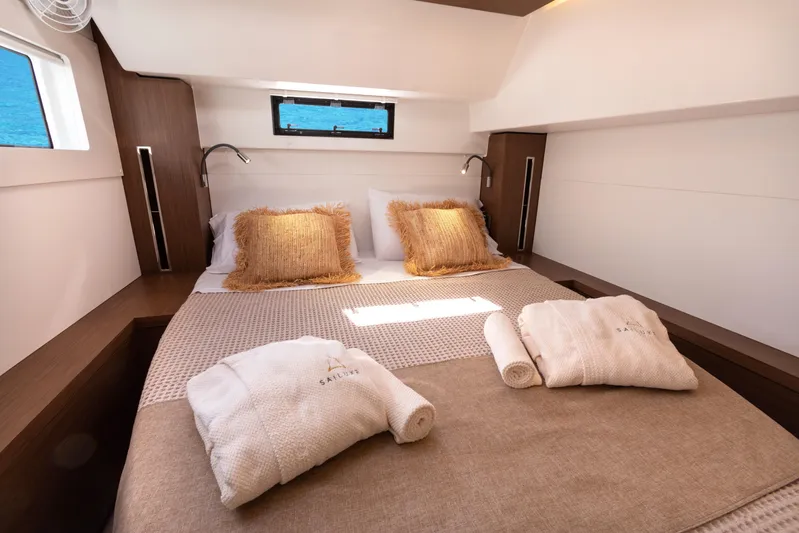 Twenty Cent Yacht Photos Pics Luxurious cabin interior of 2021 Lagoon 46 yacht with cozy bedding and elegant decor.