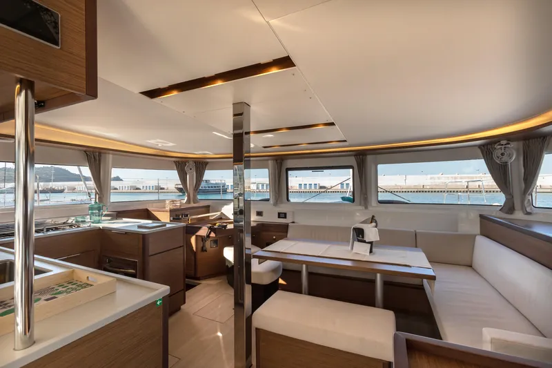 Twenty Cent Yacht Photos Pics Luxurious interior of 2021 Lagoon 46 catamaran with modern kitchen and dining area.