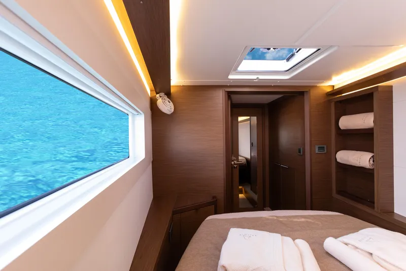 Twenty Cent Yacht Photos Pics Luxurious interior of 2021 Lagoon 46 yacht with ocean view and elegant wood finishes.