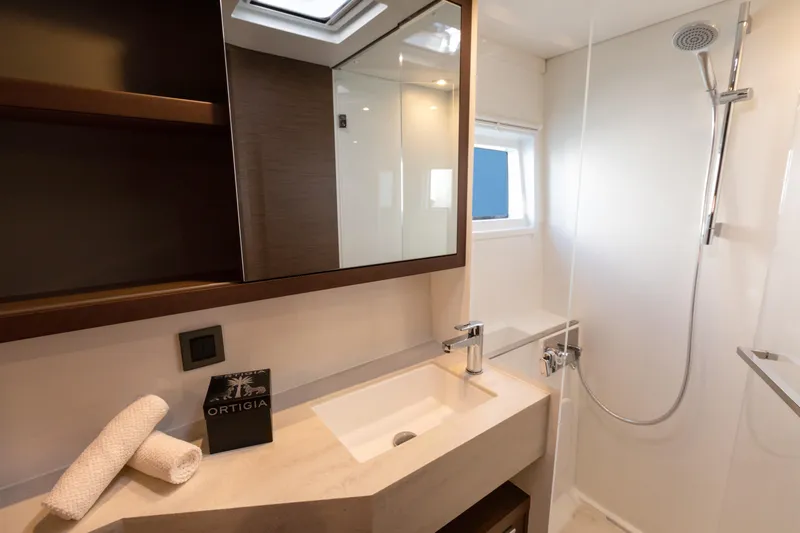 Twenty Cent Yacht Photos Pics Modern bathroom in 2021 Lagoon 46 yacht with sleek fixtures and natural lighting.