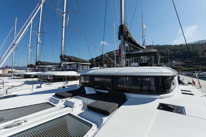Twenty Cent Yacht Photos Pics 2021 Lagoon LAGOON 46 catamaran docked in a marina under clear blue skies.