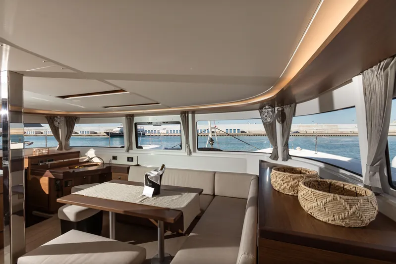 Twenty Cent Yacht Photos Pics Luxurious interior of 2021 Lagoon 46 yacht with elegant seating and ocean view.