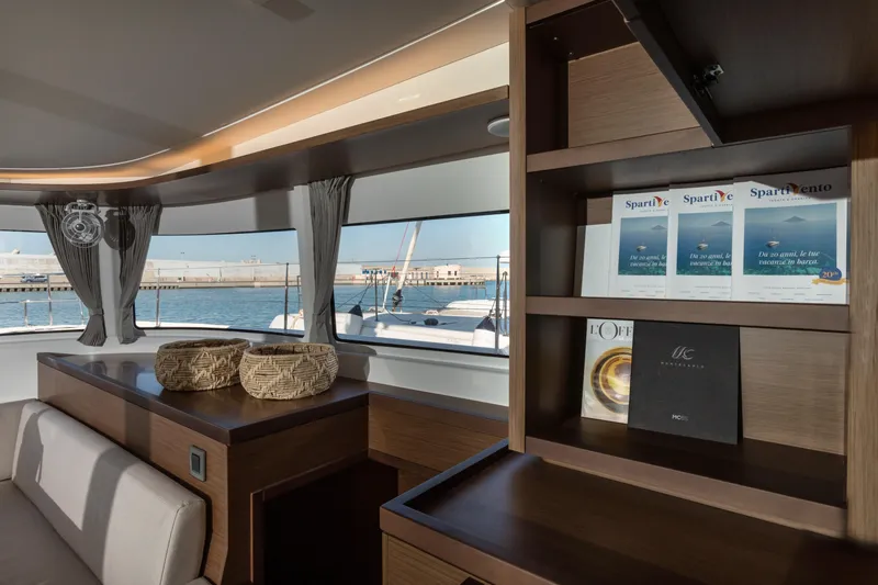 Twenty Cent Yacht Photos Pics Luxurious interior of 2021 Lagoon 46 yacht with elegant wood shelving and sea view.