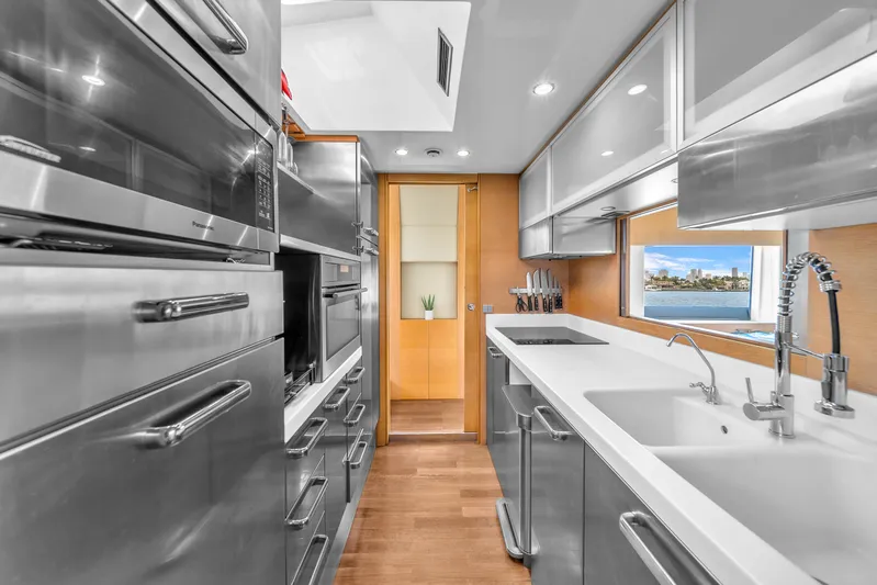 Therapy Yacht Photos Pics Modern kitchen interior on 2008 Aicon 75 Flybridge yacht, featuring sleek stainless steel appliances.