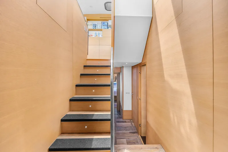 Therapy Yacht Photos Pics Interior staircase of 2008 Aicon 75 Flybridge yacht with modern wood paneling.