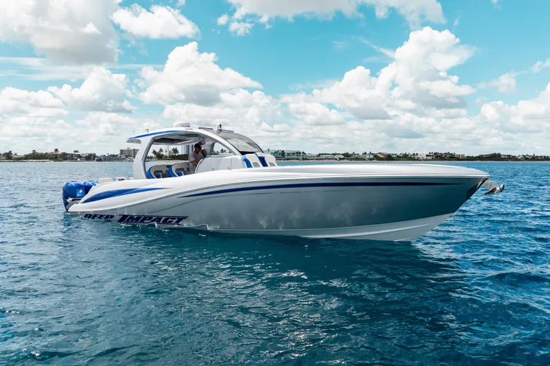  Yacht Photos Pics 2019 Deep Impact 399 Sport boat cruising on clear blue water under a partly cloudy sky.
