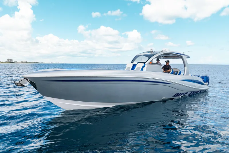  Yacht Photos Pics 2019 Deep Impact 399 Sport boat cruising on open water under a clear blue sky.