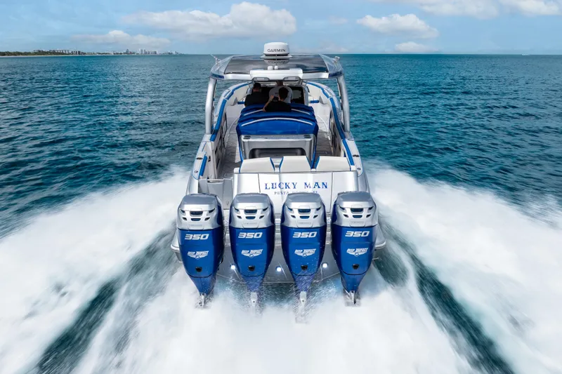  Yacht Photos Pics 2019 Deep Impact 399 Sport boat with four powerful engines cruising on open water.