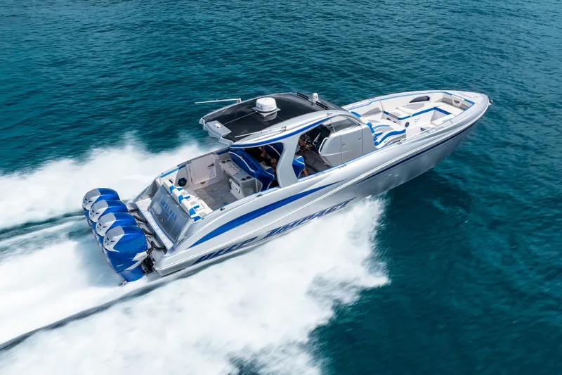  Yacht Photos Pics 2019 Deep Impact 399 Sport boat speeding on clear blue ocean waters.