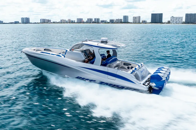  Yacht Photos Pics 2019 Deep Impact 399 Sport boat cruising on open water near city skyline.