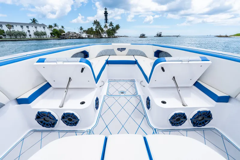  Yacht Photos Pics 2019 Deep Impact 399 Sport boat interior with blue accents, open storage, and ocean view.