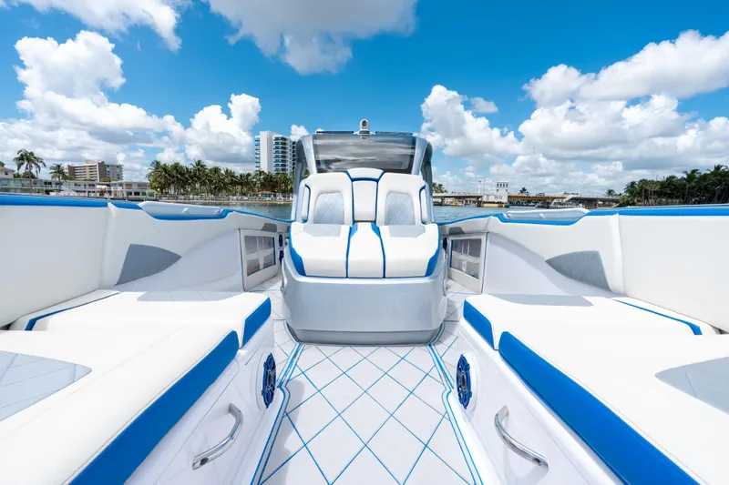  Yacht Photos Pics 2019 Deep Impact 399 Sport boat interior with white and blue seating under a clear sky.