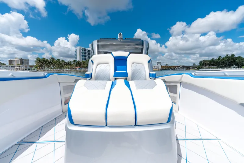  Yacht Photos Pics 2019 Deep Impact 399 Sport boat interior with blue and white seating under a clear sky.