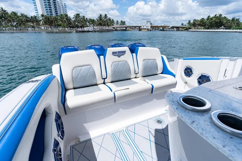  Yacht Photos Pics 2019 Deep Impact 399 Sport boat interior with blue and white seating, ocean view.