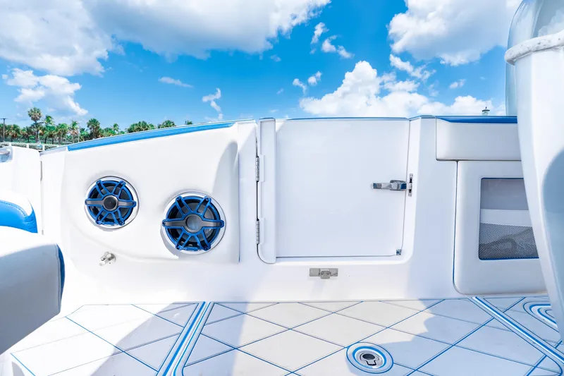  Yacht Photos Pics 2019 Deep Impact 399 Sport boat interior with speakers, blue accents, and clear sky.