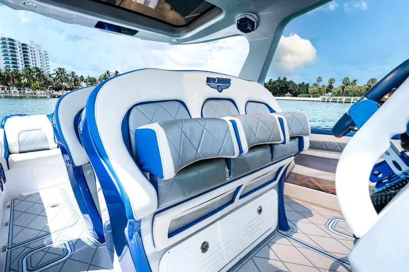  Yacht Photos Pics Luxurious interior of 2019 Deep Impact 399 Sport boat with blue and white seating.