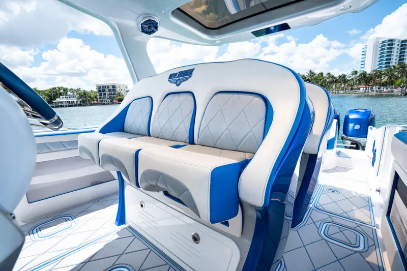  Yacht Photos Pics Luxurious interior of 2019 Deep Impact 399 Sport boat with blue and white seating.