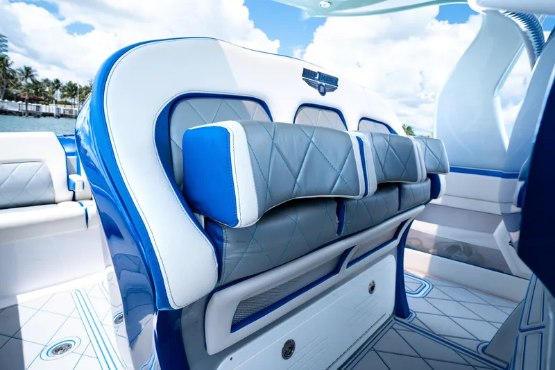  Yacht Photos Pics 2019 Deep Impact 399 Sport boat interior with luxurious blue and white seating.