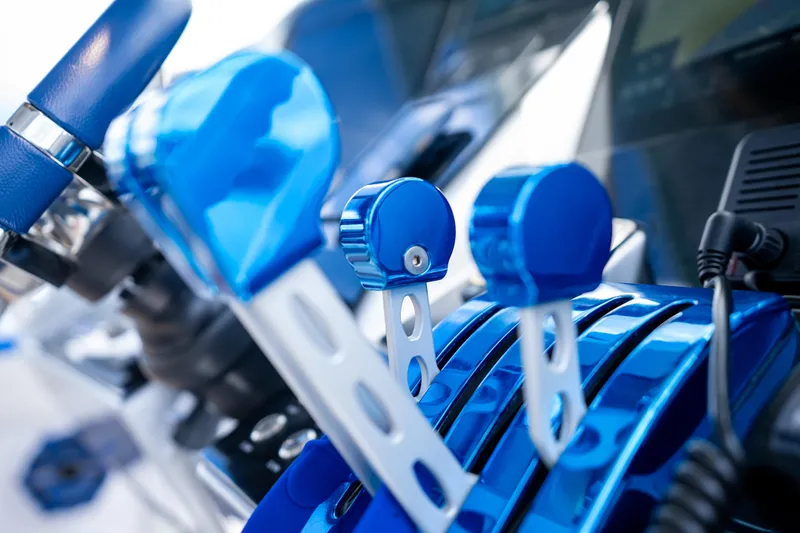  Yacht Photos Pics Close-up of 2019 Deep Impact 399 Sport boat controls in vibrant blue.