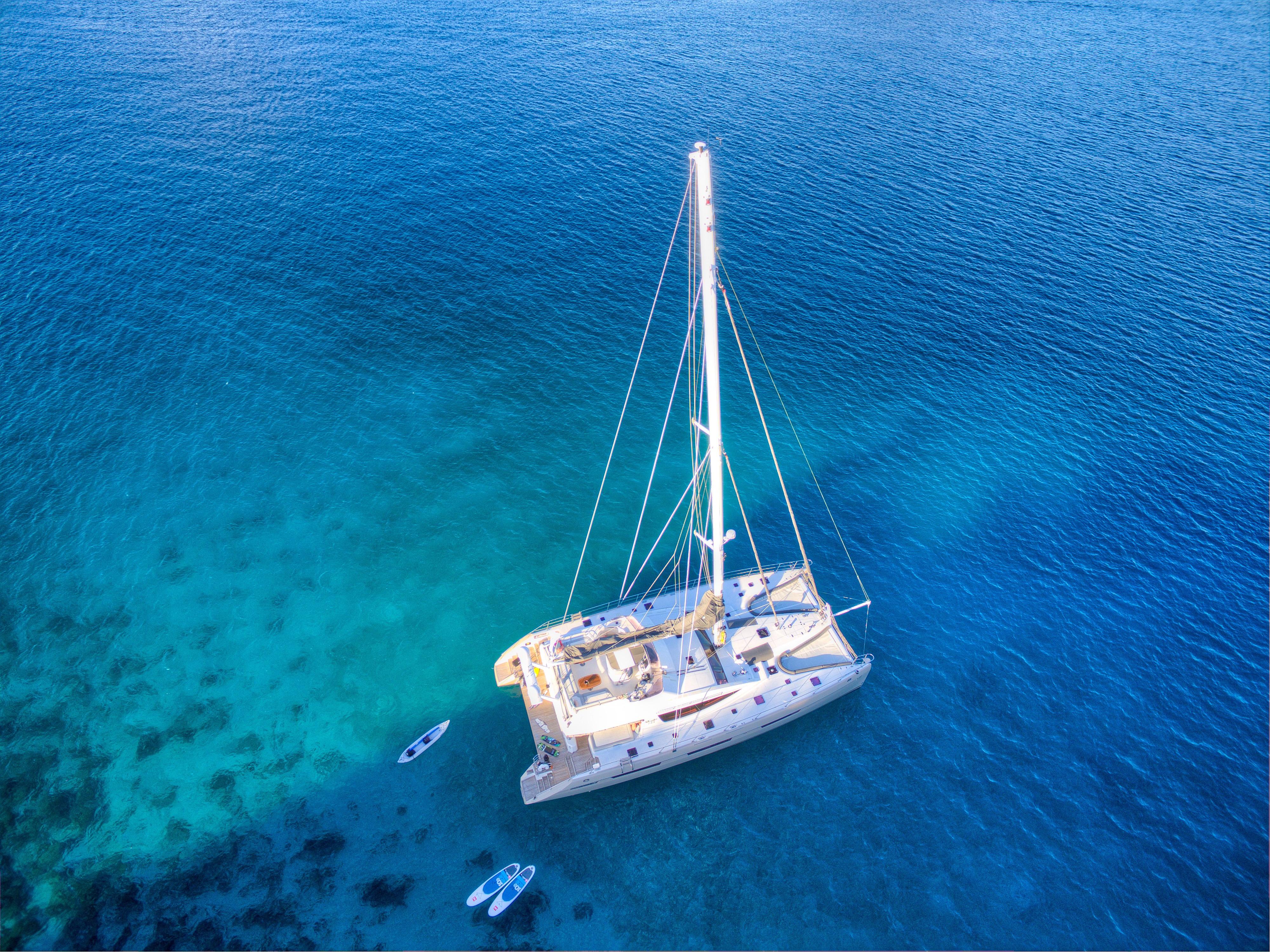 Aerial view of 2010 Privilege 745 yacht anchored in clear blue waters.