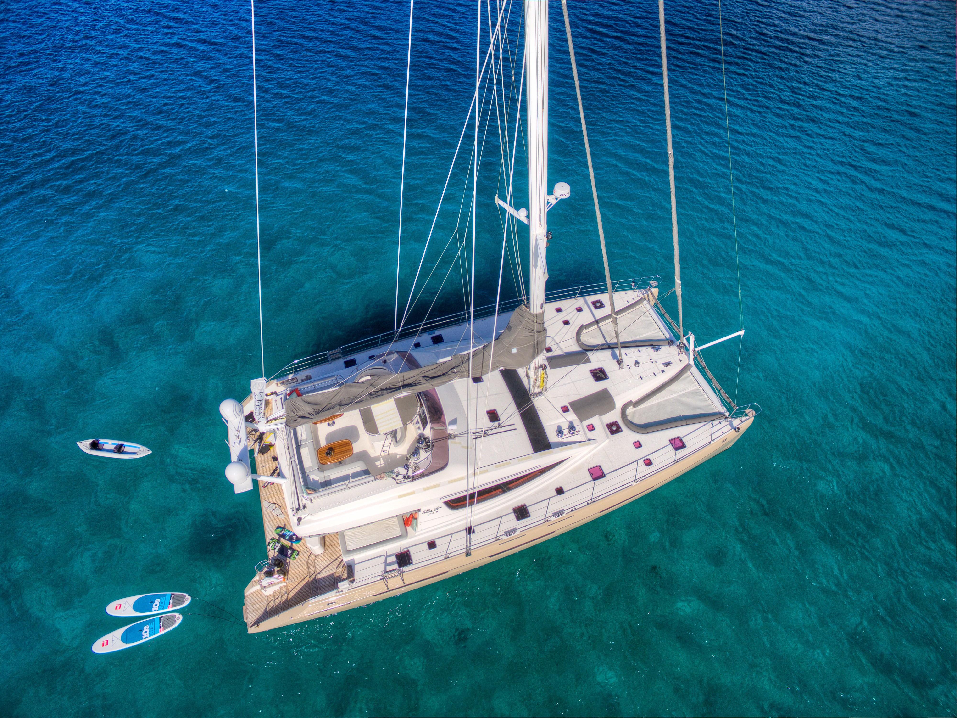 Aerial view of 2010 Privilege 745 yacht anchored in clear blue water.