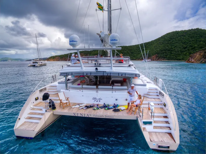  Yacht Photos Pics Luxury Privilege 745 yacht, 2010 model, anchored in scenic tropical waters with lush green hills.