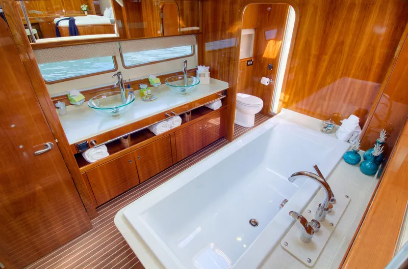  Yacht Photos Pics Luxurious bathroom on a 2010 Privilege 745 yacht with double sinks and a large bathtub.