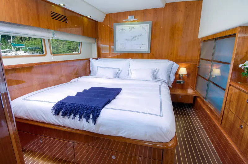  Yacht Photos Pics Luxurious bedroom in 2010 Privilege 745 yacht with wooden interiors and large bed.