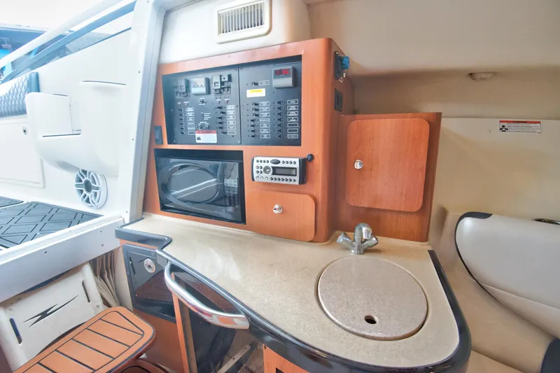  Yacht Photos Pics 2006 Hydra-Sports Vector 3300 VX cabin interior with kitchenette and control panel.