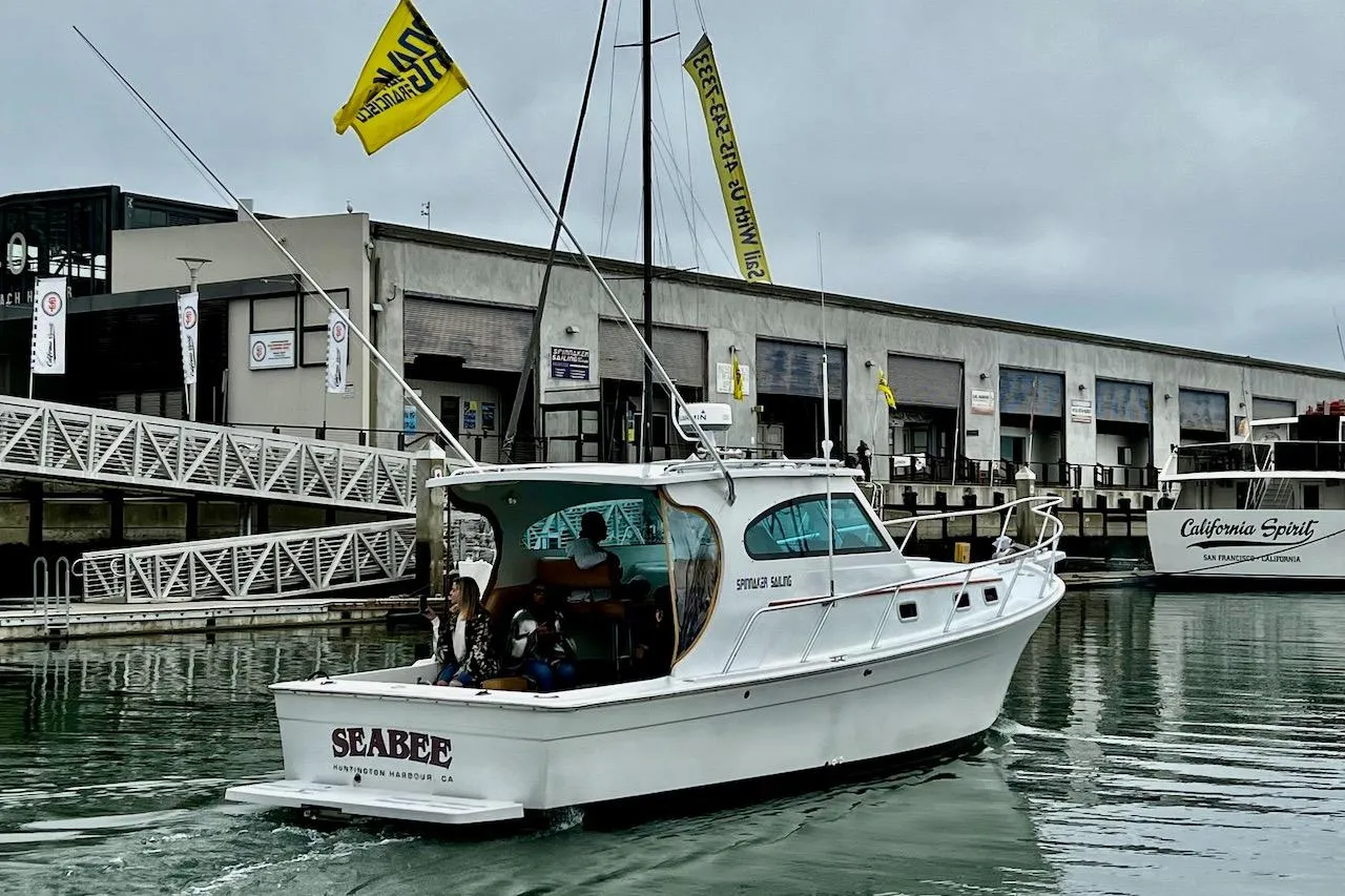 1999 Mainship Pilot 30 boat named "Seabee" docked at a marina.