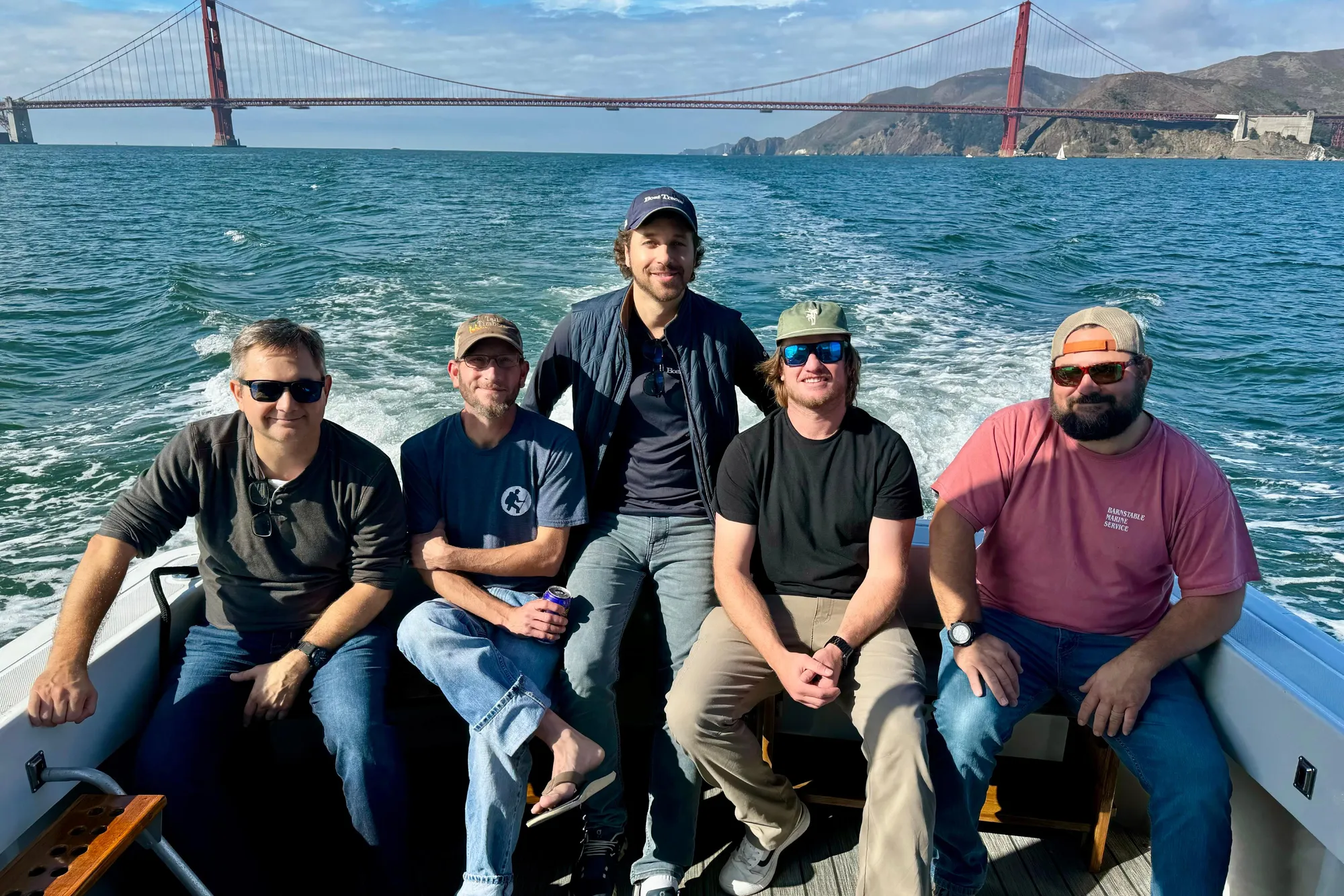 Group of five men on a 1999 Mainship Pilot 30 boat near Golden Gate Bridge.