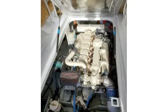 Engine compartment of a 1999 Mainship Pilot 30 boat, showcasing the engine and components.