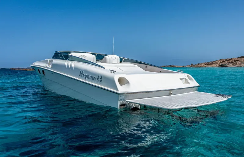 White Chocolate Yacht Photos Pics 2003 Magnum 44 boat on clear blue water, sunny day, coastal background.