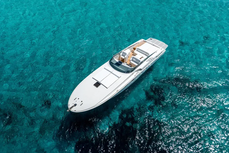 White Chocolate Yacht Photos Pics Aerial view of 2003 Magnum 44 yacht on clear turquoise water.