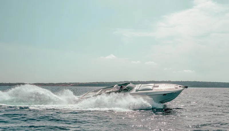 White Chocolate Yacht Photos Pics 2003 Magnum 44 speedboat cruising on open water under a clear sky.
