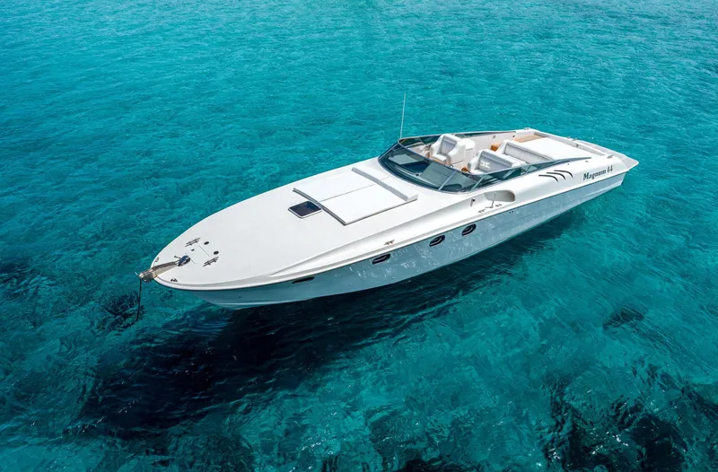 White Chocolate Yacht Photos Pics A 2003 Magnum 44 boat on clear turquoise water.