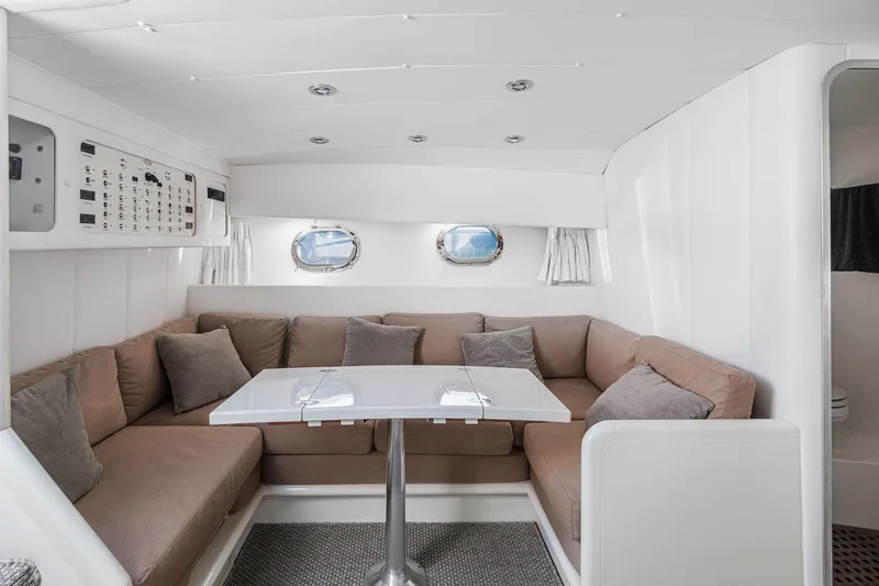 White Chocolate Yacht Photos Pics Interior of 2003 Magnum 44 yacht with cozy seating and modern design.