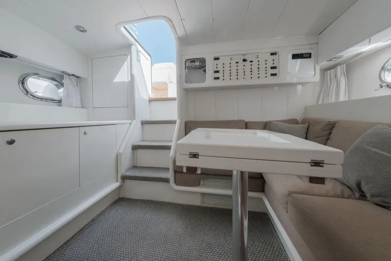 White Chocolate Yacht Photos Pics Interior of 2003 Magnum 44 yacht with modern seating and control panel.