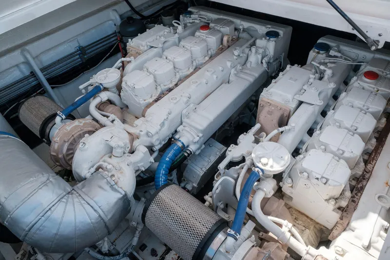 White Chocolate Yacht Photos Pics Engine compartment of a 2003 Magnum 44, showcasing dual engines and mechanical components.