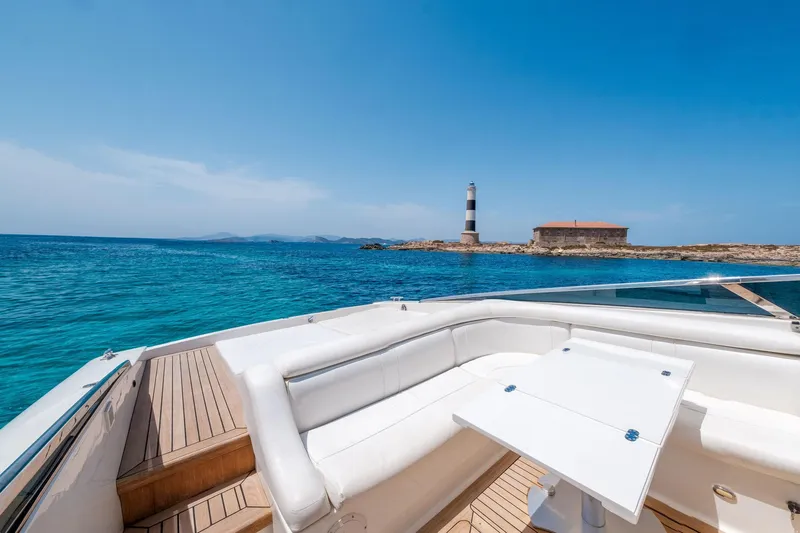 White Chocolate Yacht Photos Pics Luxury Magnum 44 yacht deck with ocean view and distant lighthouse, 2003 model.