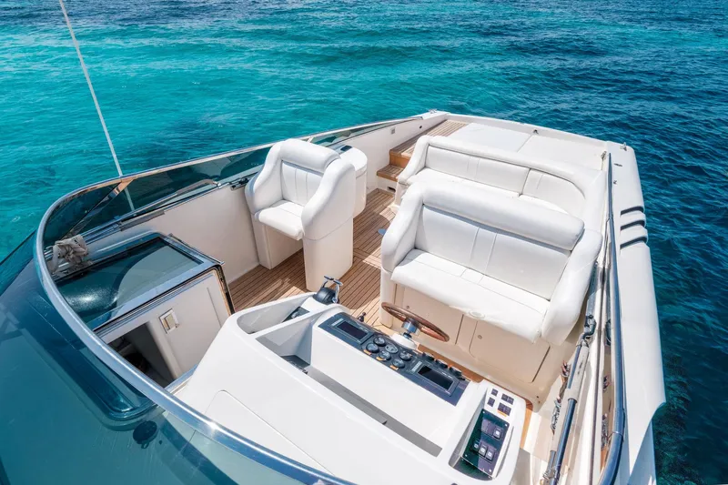 White Chocolate Yacht Photos Pics Luxurious Magnum 44 yacht interior, 2003 model, with white seating and turquoise ocean backdrop.