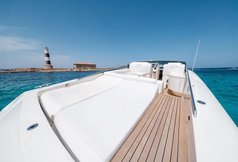 White Chocolate Yacht Photos Pics Luxury Magnum 44 yacht cruising near a lighthouse, clear blue skies, 2003 model.