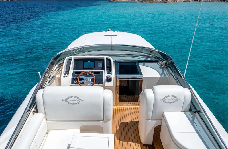 White Chocolate Yacht Photos Pics Luxury Magnum 44 yacht interior, 2003 model, with sleek design and turquoise water backdrop.