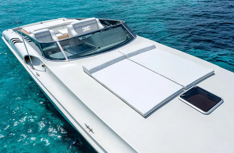 White Chocolate Yacht Photos Pics 2003 Magnum 44 boat on clear blue water, showcasing sleek design and luxury features.